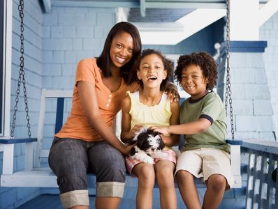 Picture of a mother with her two children during happy moments.