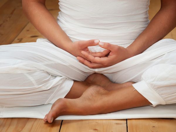 Woman sitting in relax pose waiting to start yoga.