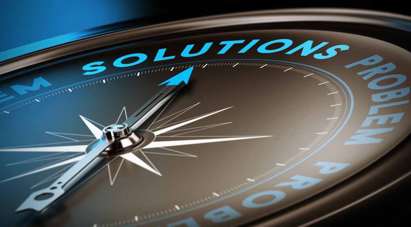 Compass needle pointing towards the word 'Solutions' in blue.