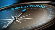 A compass pointing to the word 'Solutions' symbolizing guidance.