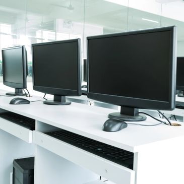 Empty desks with computer blank monitors