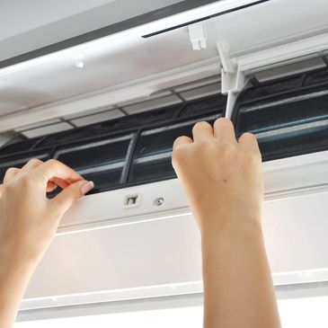 a person's hands on an AC