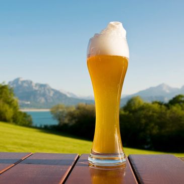 Glass of beer on a table with mountain scenery