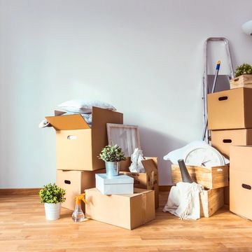 Packed moving boxes and household items ready for relocation.