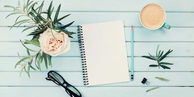 Notebook and coffee on table