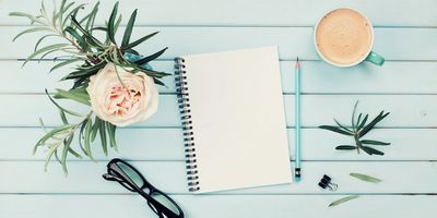 Notepad with coffee on table