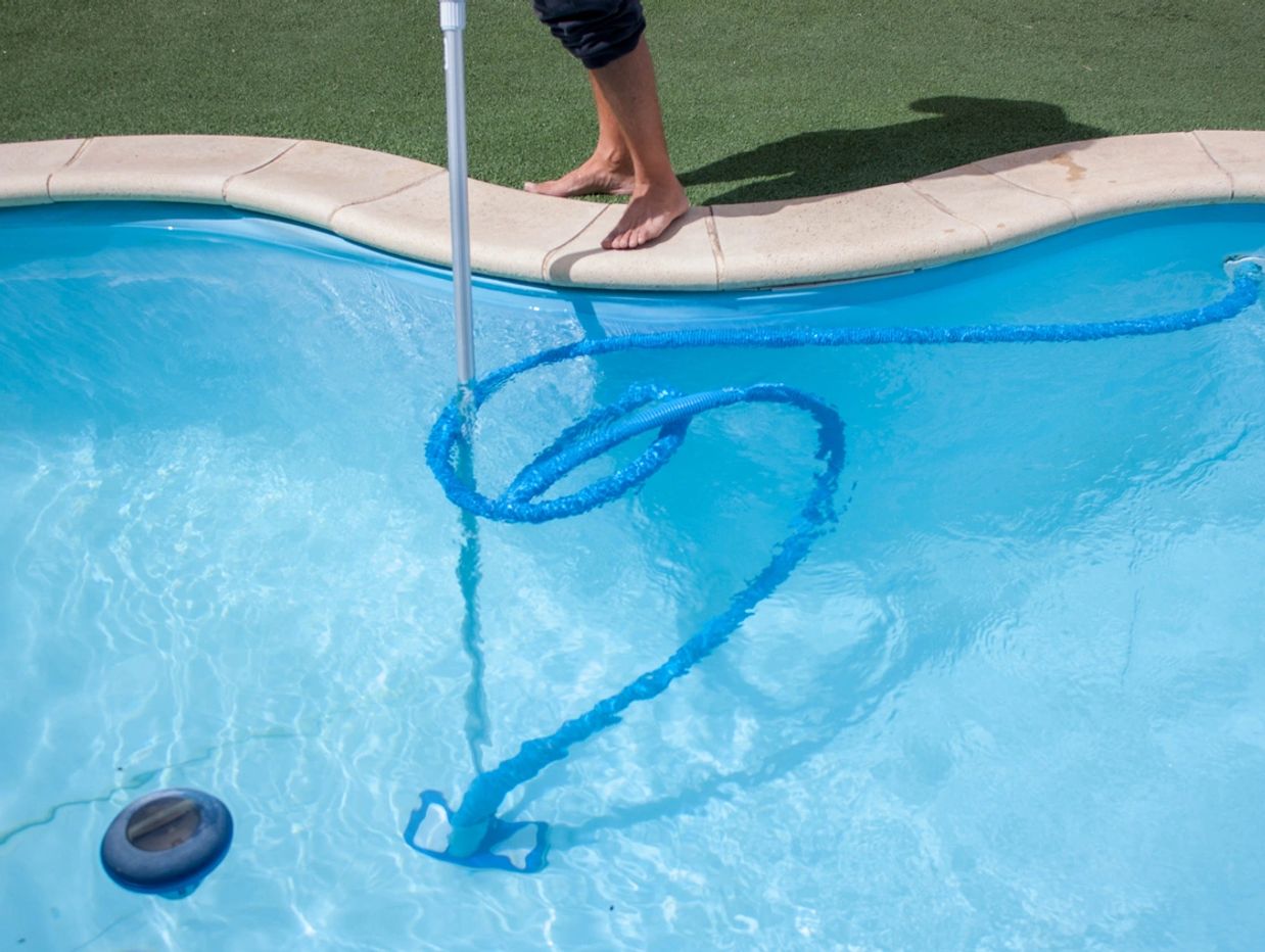 Person Cleaning Swimming Pool