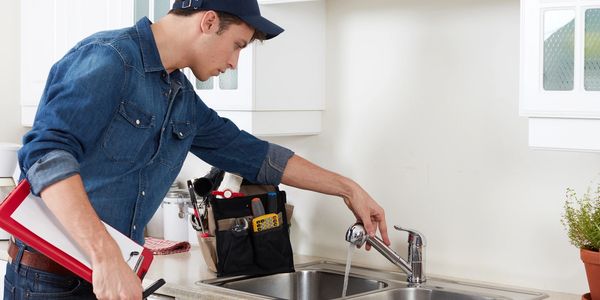 Plumber checking water pressure in the sink