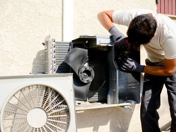a person working on an HVAC unit
