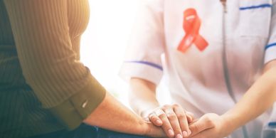 health care provider holding a female patient's hand