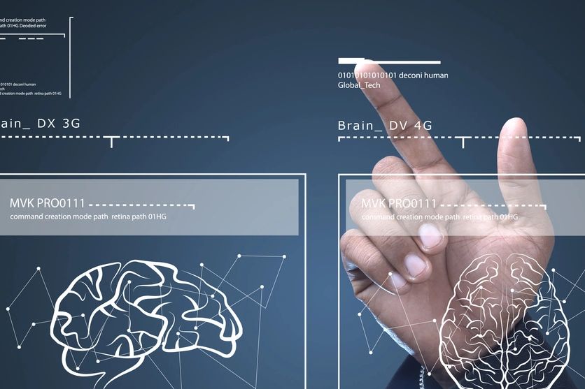 Hand interacting with futuristic brain interface displaying neural connections and data.
