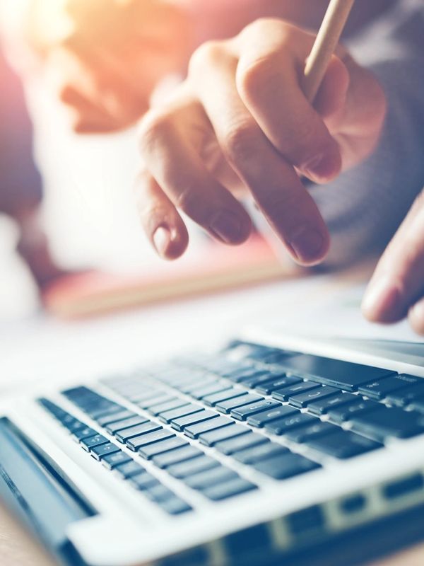 Hands typing on a computer keyboard