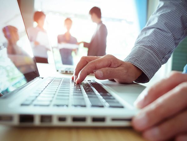 man writing  on the laptop