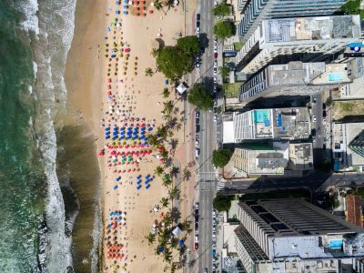 Aerial view of a colorful beach and adjacent city buildings.