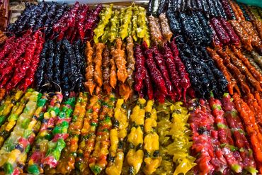 Colorful rows of traditional Georgian churchkhela sweets on display.