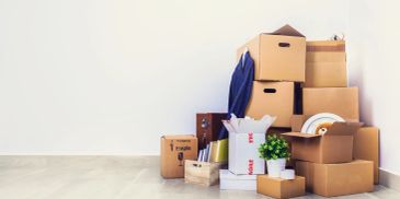 Stack of cardboard boxes and packed items ready for moving.