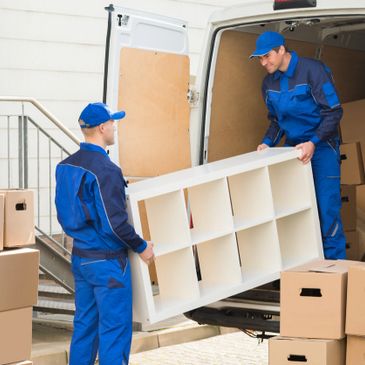 furniture being carefully moved into the moving truck