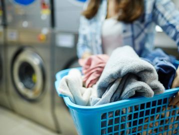 Woman carrying laundry in a laundry basket