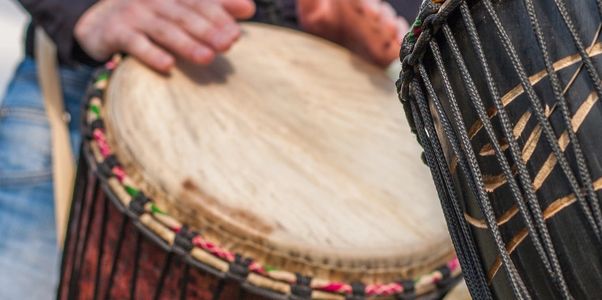 A music therapist leading a drum therapy circle