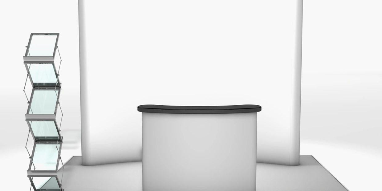 Minimalist trade show booth with curved counter and glass brochure stand.