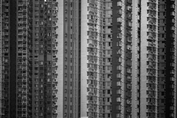 Tall residential buildings with many windows in black and white.