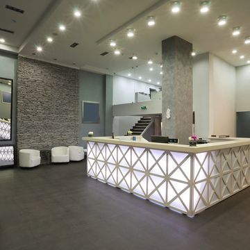 Modern reception area with illuminated front desk and stylish seating.