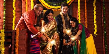 A family celebrating festival with simple flower decor, yellow and orange marigold flower and leaves