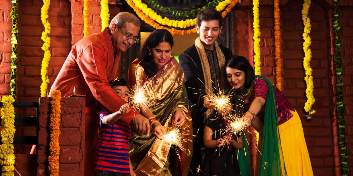 Family lighting sparklers during a festive celebration.
