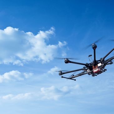 Close up shot of a moving drone in black color in the air