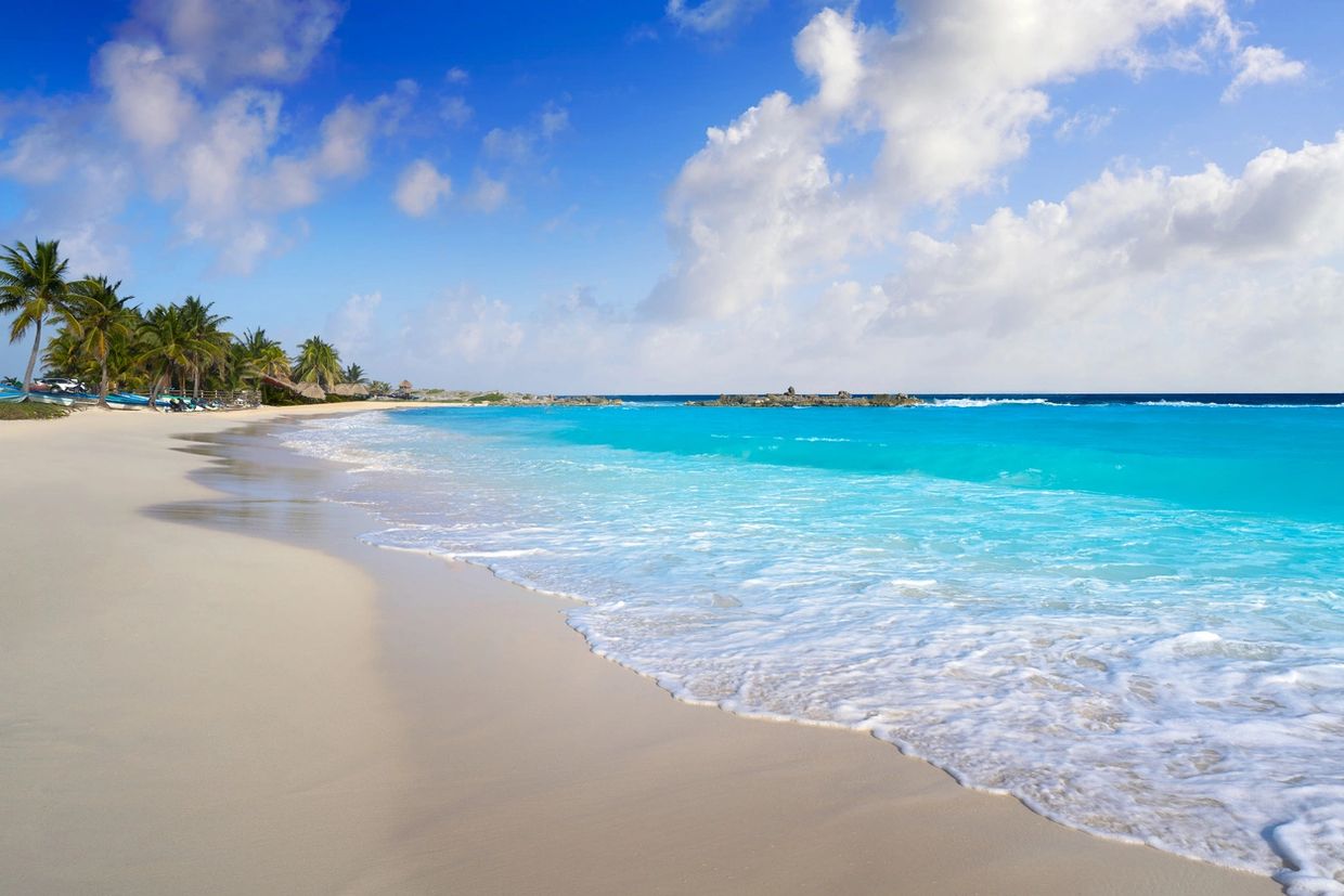 Caribbean water on white sand beach.