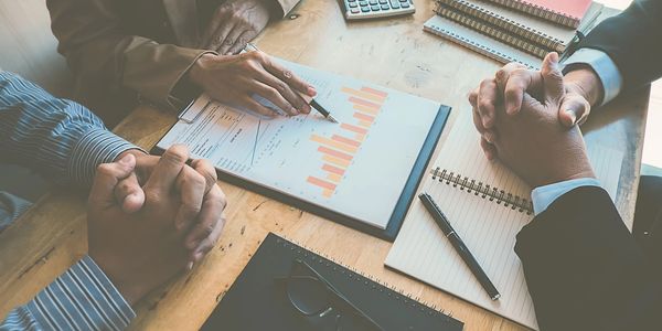 Accountant and clients going over financial reports of there business