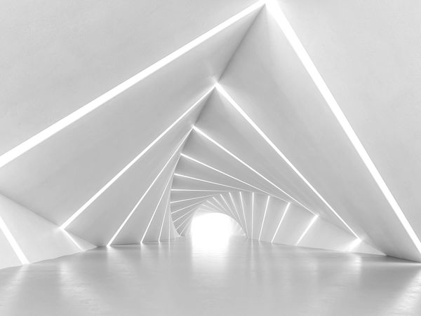 A white room with a pointed ceiling highlighted with lights from the ground up