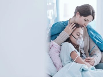 A mother comforting her sick child in hospital.