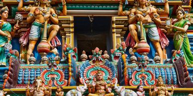 Intricately painted Hindu temple sculptures with vibrant colors and detailed carvings.