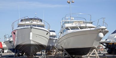 Boats for sale sitting on hard stand at a marine shipyard
