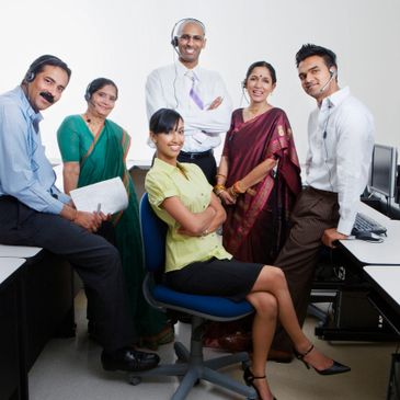 People working in a call centre posing for photo