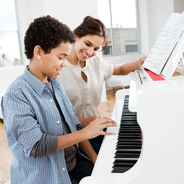 smiling child during a piano lesson