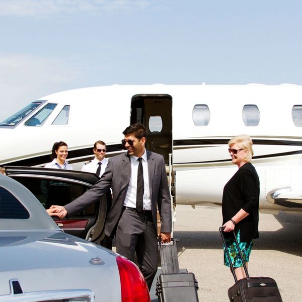A scenic landscape featuring mountains, a lake, and a clear blue sky.