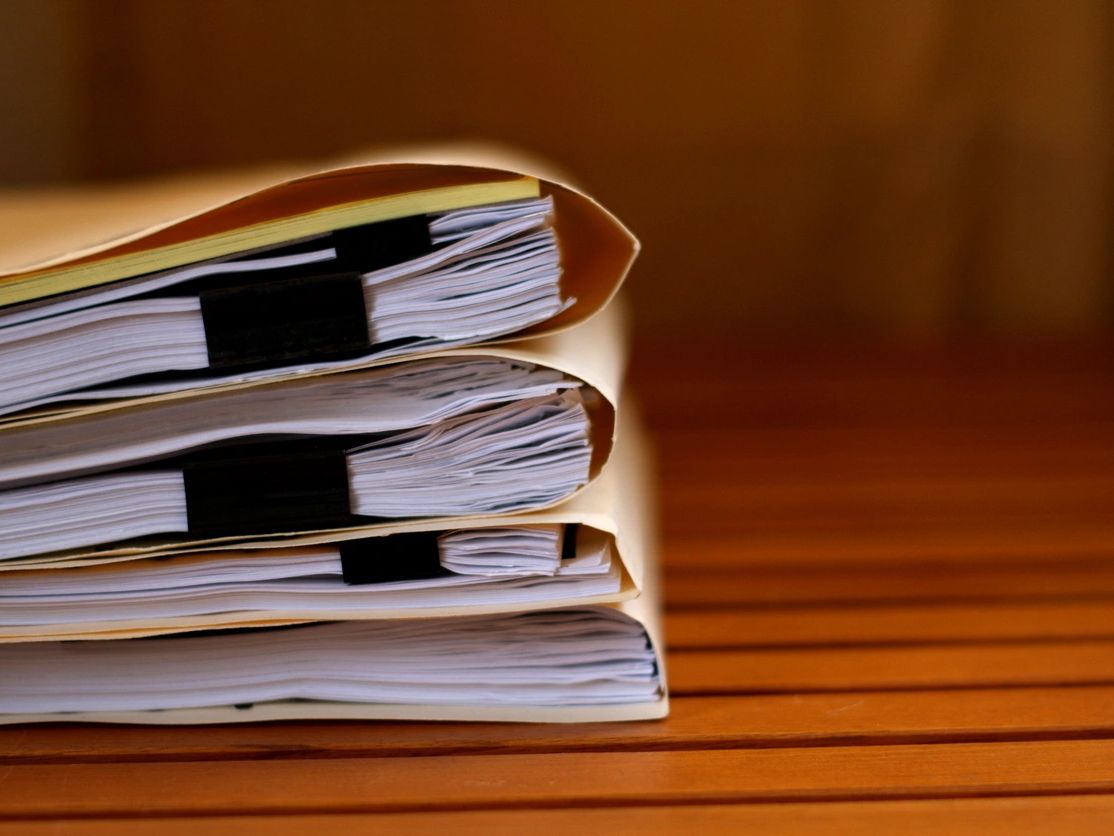 Stack of manilla folders filled with paper documents