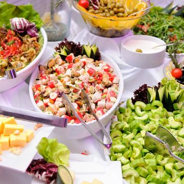 A vibrant salad buffet with fresh vegetables, cheese, and olives.