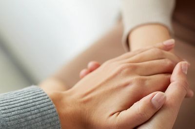 Person holding another person's hand 