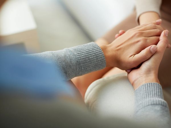 PTSD Mental health concept, psychologist sitting and touching hand of depressed