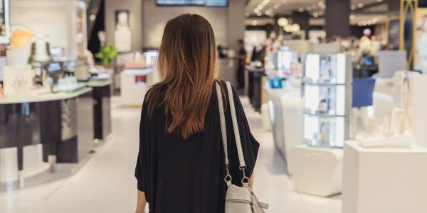 Woman with long hair shopping in a bright, modern store.
