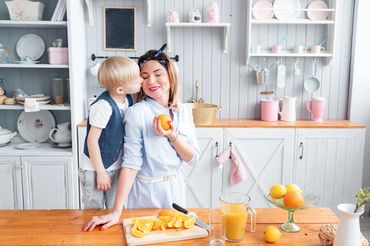 mom and child in kitchen with lemons