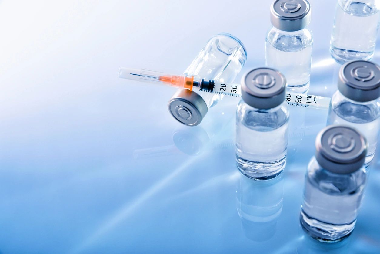 An insulin needle surrounded by several vials of medication. Click the link for more information regarding hormone replacement therapy for men and women between the ages of 30 and 65 suffering from low testosterone in Pueblo Colorado.