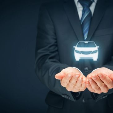 Businessman holding holographic car icon.