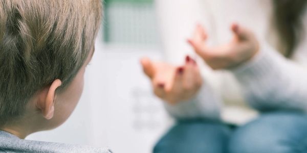 Woman talking to young child