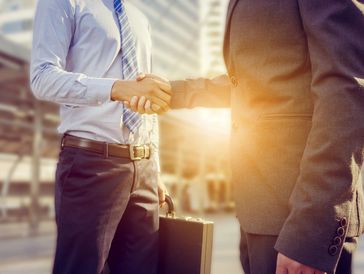 stakeholders shaking hands.