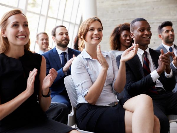 People clapping with smiling faces