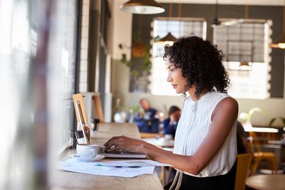 A person sitting in front of a laptop